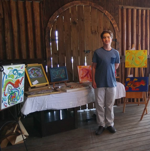Lucas-Kaighin-with-his-paintings