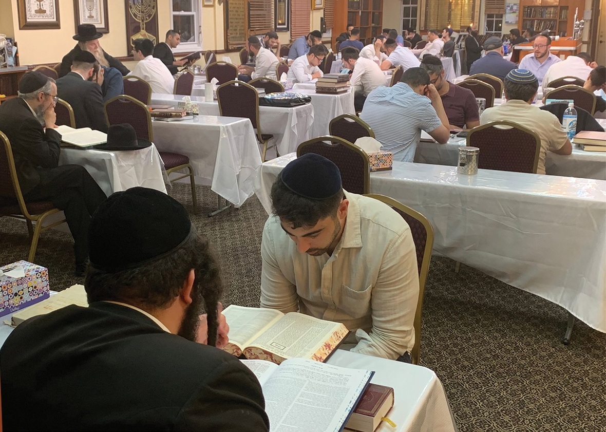 People learning in a Beis Midrash in Queens N.Y. during a Night Torah Learning Program of CHAVRUTA